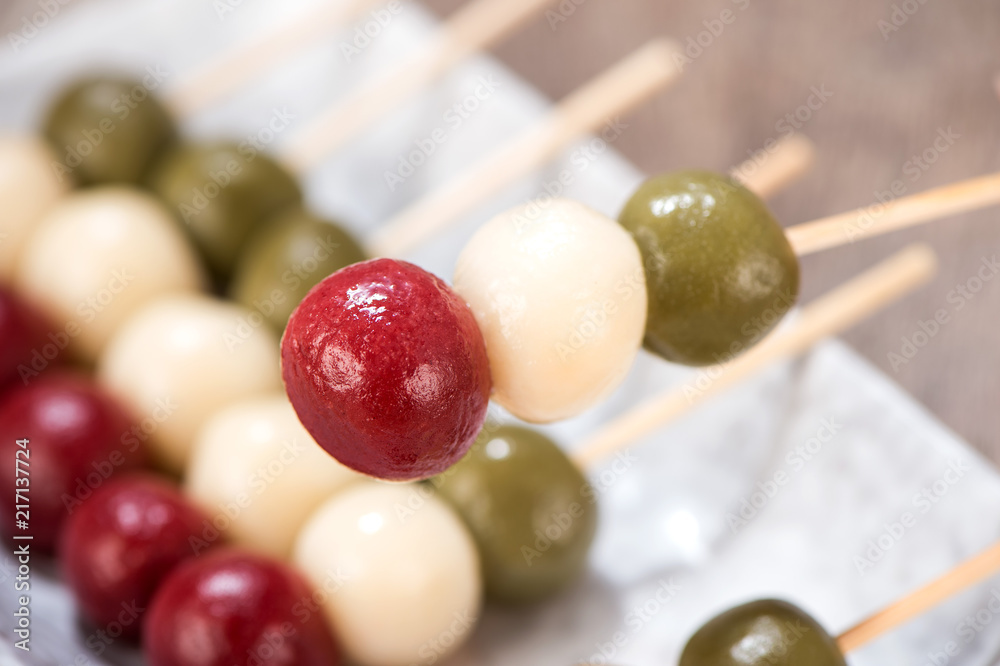 Japanese Dango dessert with 3 different color in pink(red), white, and green, recipe, hanami Dango, tsukimi Dango, copy space. Japanese Dango dessert with 3 different color in pink(red), white, and green, recipe, hanami Dango, tsukimi Dango, copy space.