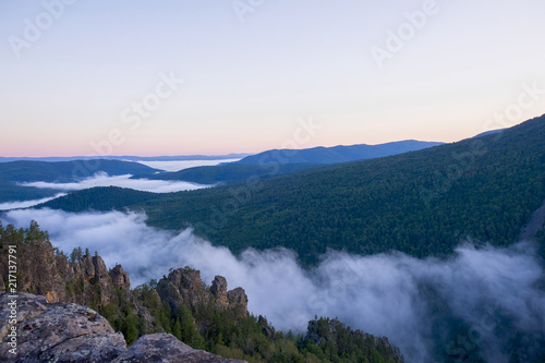Fototapeta Naklejka Na Ścianę i Meble -  Dawn on top of the mountain. The fog at the bottom