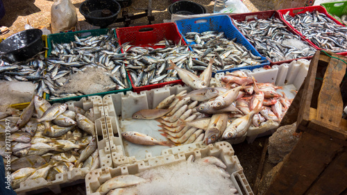 Traditional food street market in Morocco. Fish stall on the floor.