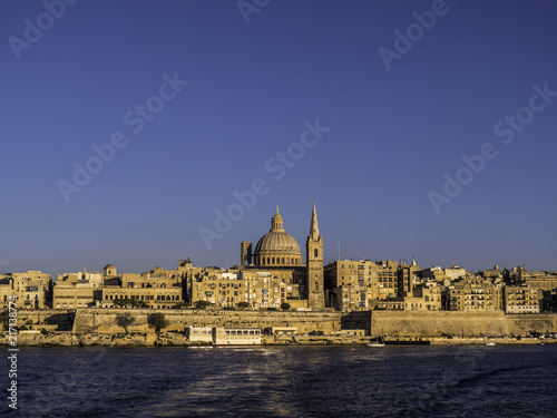 Skyline of Valletta Old Town from the Harbour during sunset hour