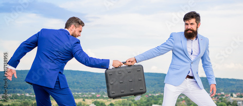 Canvas-taulu Businessman takes away briefcase from business partner