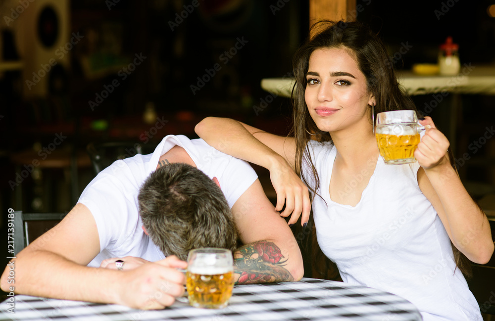 Enough for him. Best friends or lover drink beer in pub. Couple in love on  date