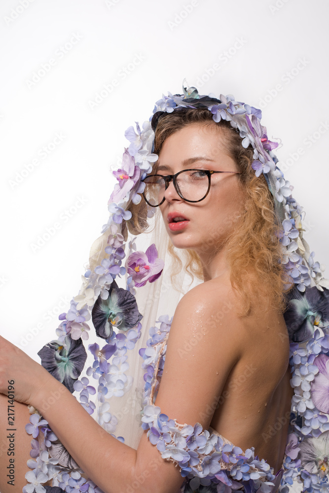Pretty girl with glasses and with orchids on head on white background. Fashion Beauty Concept Pretty girl with glasses and with orchids on head on white background. Fashion Beauty Concept