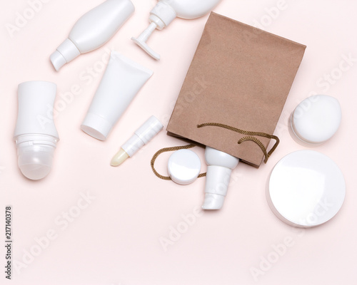 Cosmetic products with paper bag - beauty shopping concept flat lay