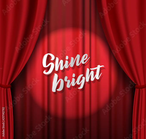 Teather stage with red heavy curtain with golden text and stars.
