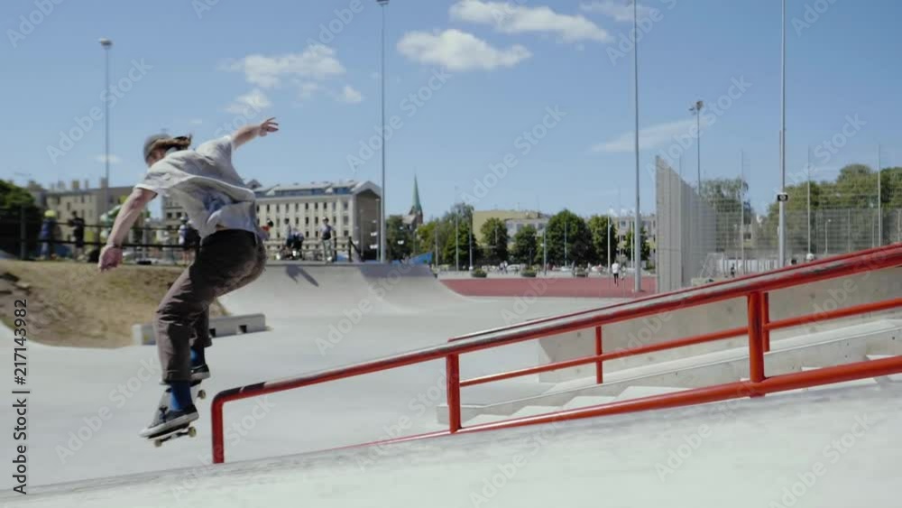 Young skater doing tricks outdoors. Slowmotion video 150fps