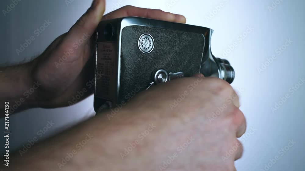 Man sets up and begins shooting with old 8mm film camera