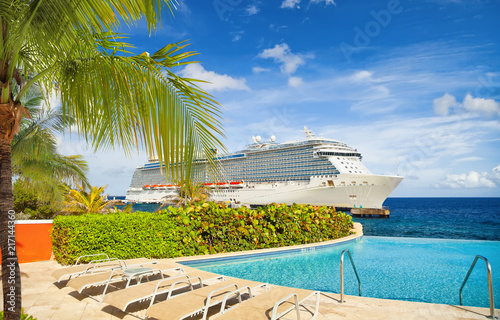 View from pool at tropical resort on cruise ship docked at port 