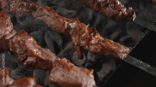 Top view of barbecue being flipped over the hot coals on the grill photo