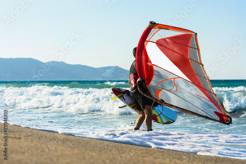 Windsurfer in the sea on Crete on sunset. Windsurfing in Heraklion