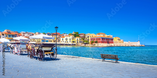 Panorama of the old harbor of Chania with horse carriages, Crete, Greece.