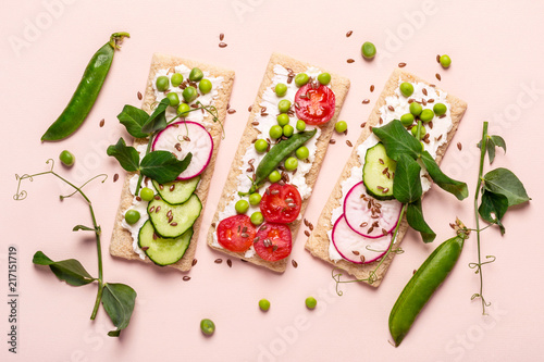 Healthy sandwiches with soft cheese and raw vegetables on crisp bread
