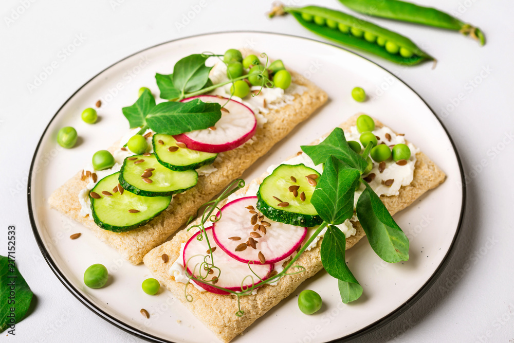 Healthy sandwiches with soft cheese and raw vegetables on crisp bread Healthy sandwiches with soft cheese and raw vegetables on crisp bread