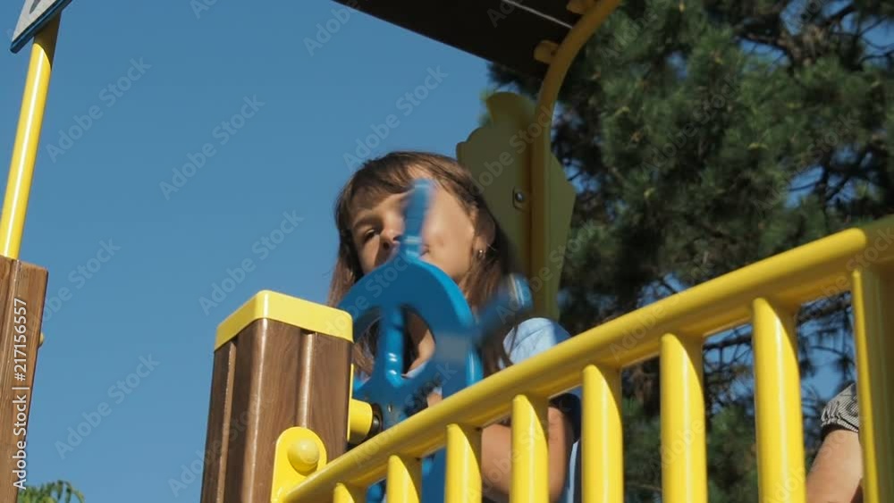 Child in the playground. Little girl is playing in the playground. Child in the playground. Little girl is playing in the playground.