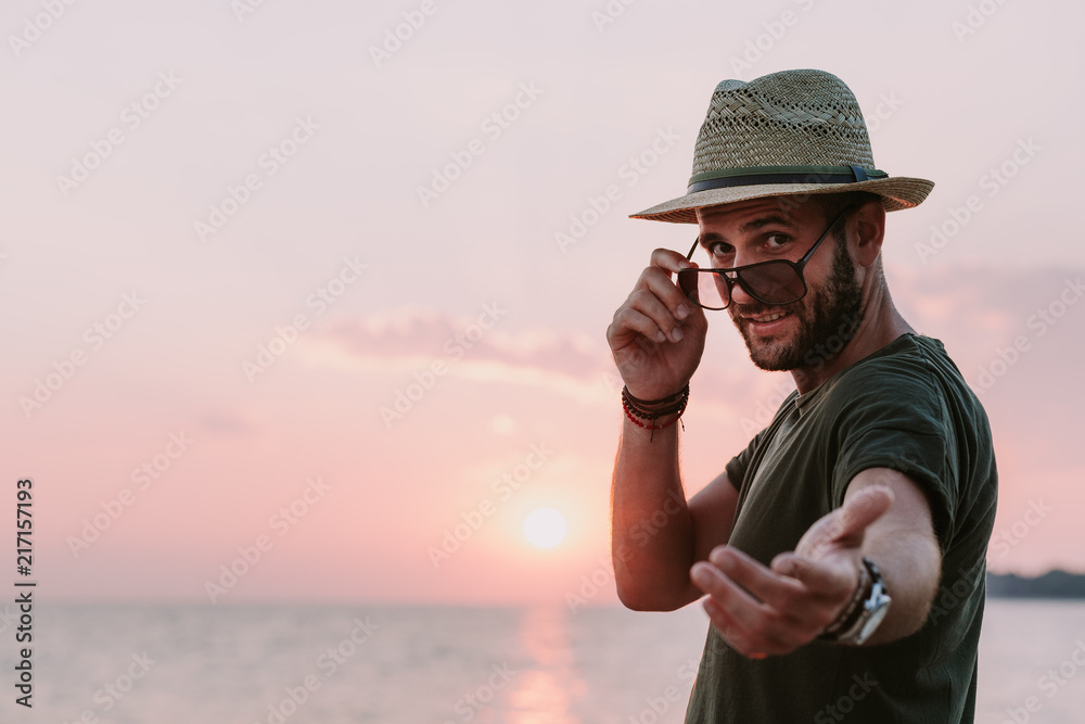 Young man enjoying sunset by the sea Young man enjoying sunset by the sea