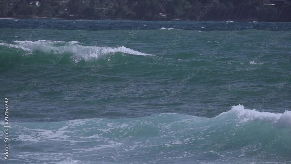 Surfing in the rain,water sport concept. Happy surfer man swimming out waiting for a big wave in heavy rain at patong bay,hd slow motion.