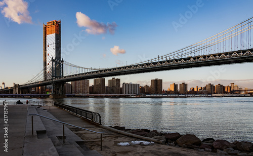 Manhattan Bridge  as seen from Dumbo Park in late evening with a few puffy clouds