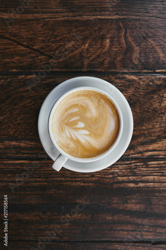 top view of cup of delicious coffee on rustic wooden table