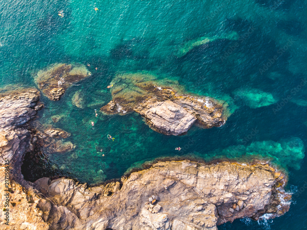 People Snorkling at Cabo de Palos, Spain, Murcia, Cartagena, Summer 2018. Volcanic mounts that form a small peninsula, drone arial shoot from drone