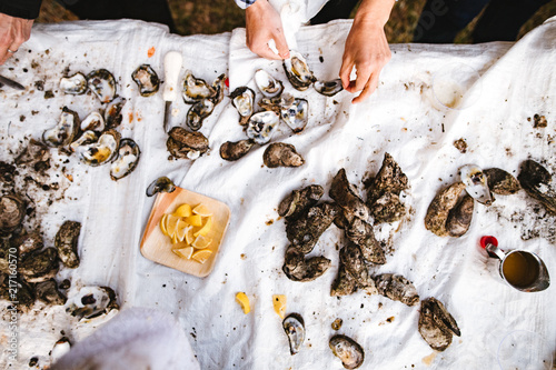 Guests shucking oysters at an oyster roast photo