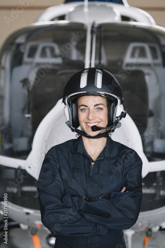 Portrait attractive woman helicopter pilot In the hangar