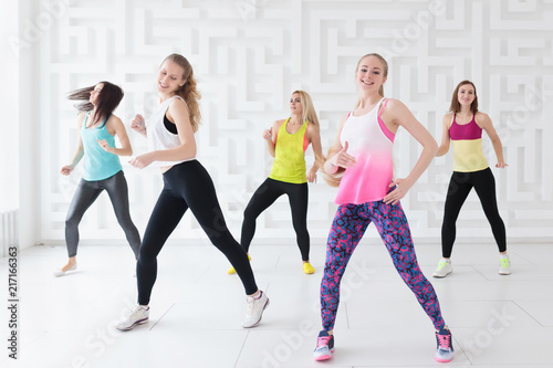 Happy young women having a calorie-burning dance