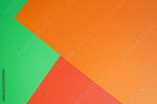 Unique background of bright paper sheets. Green, red and orange.