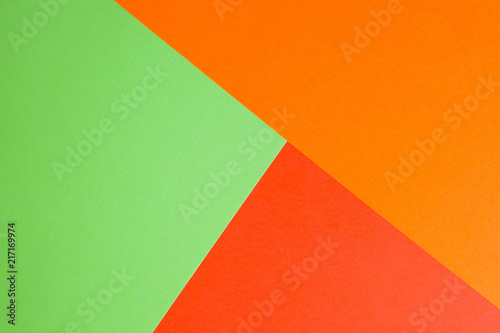 Lovely background of bright paper sheets. Green, red and orange.