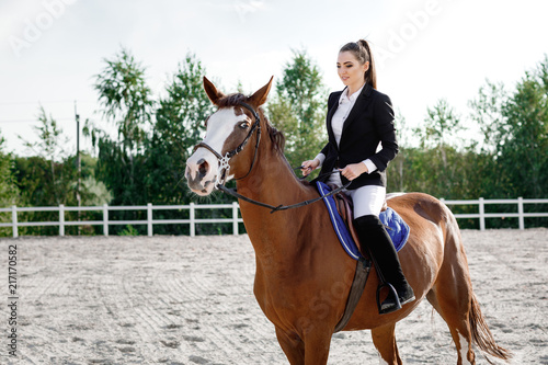 Rider elegant woman riding her horse outside