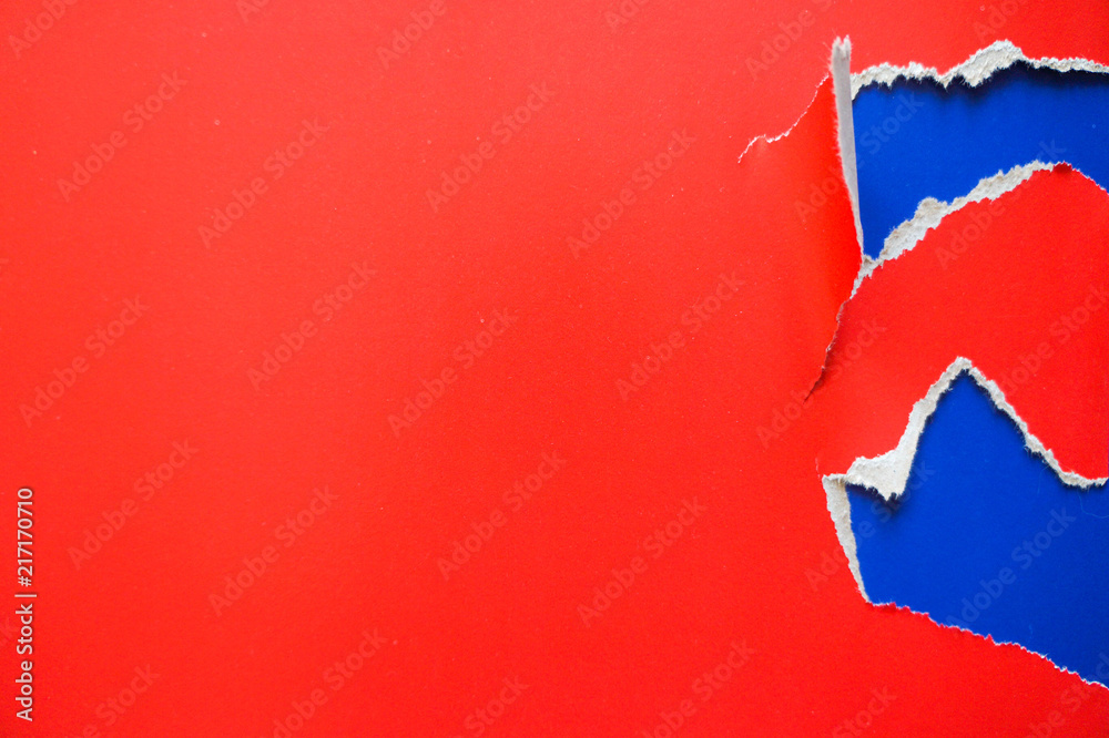 Fototapeta premium Fashion flat lay background with color fragmentary paper. Red and blue.