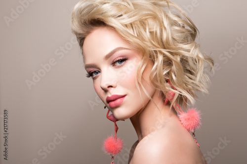 Glamour portrait of beautiful girl model with makeup and romantic wavy hairstyle. Fashion shiny highlighter on skin  sexy gloss lips make-up and dark eyebrows.
