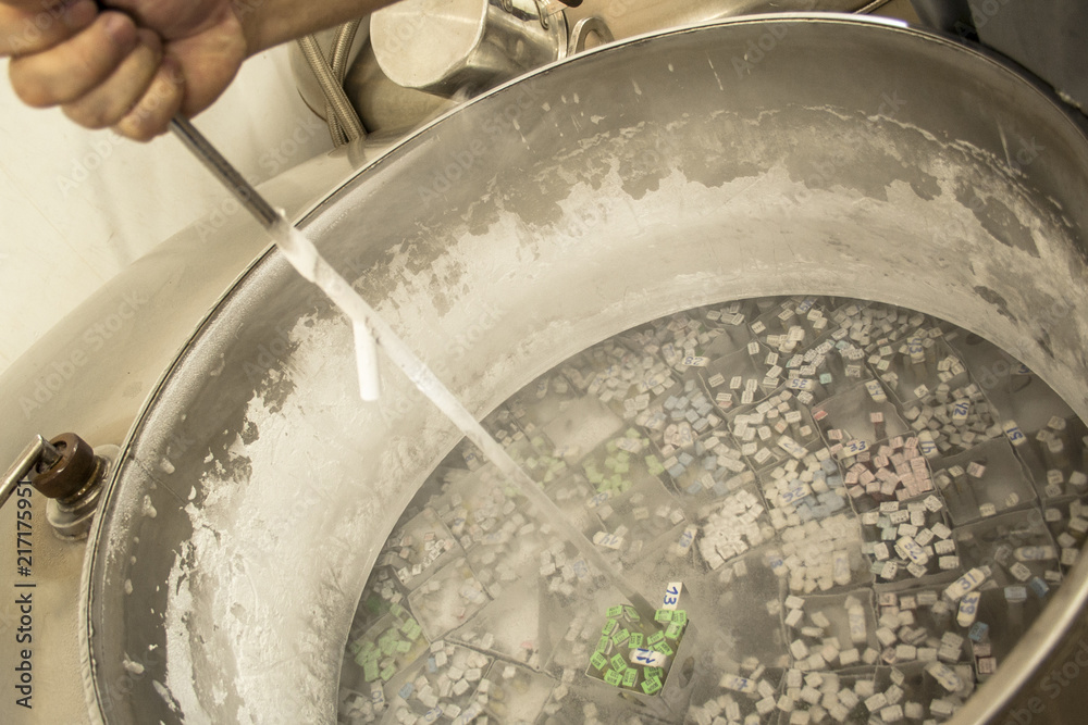 Ταπετσαρία Worker handles frozen bovine semen inside a container with liquid nitrogen in an artificial insemination lab