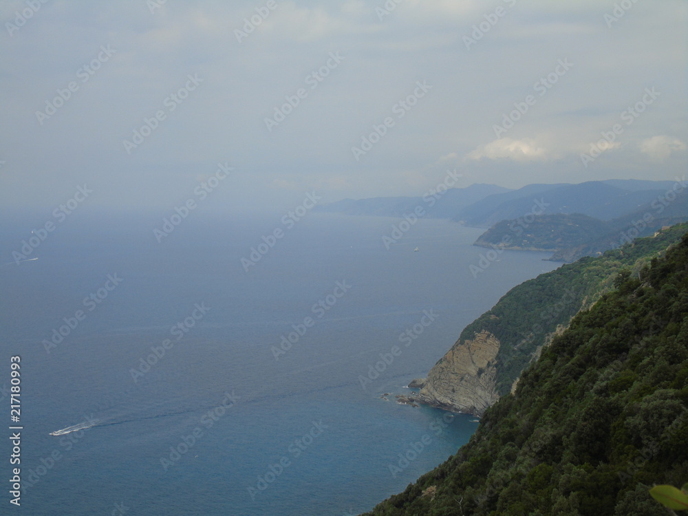 An amazing caption of the beautiful places from the 5 Terre in Liguria with an amazing blue sky and some green mountains in the background An amazing caption of the beautiful places from the 5 Terre in Liguria with an amazing blue sky and some green mountains in the background