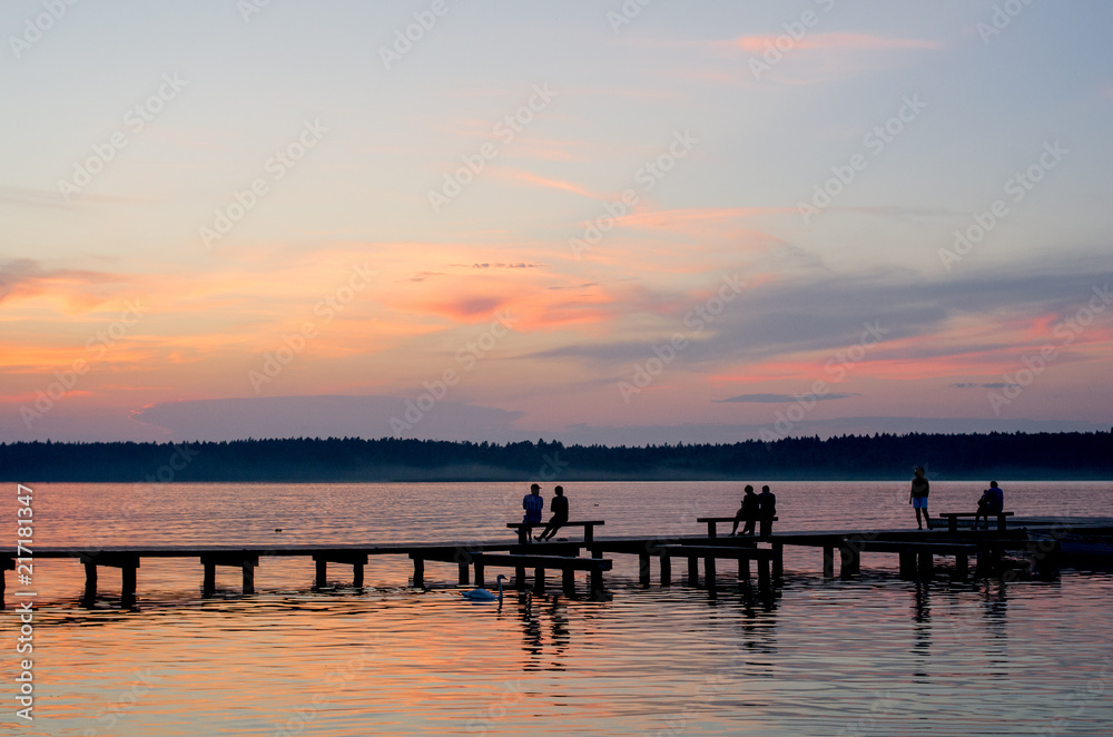 Sunset over the fishing pier at the lake in rural Poland.