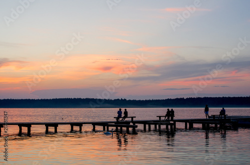 Sunset over the fishing pier at the lake in rural Poland.