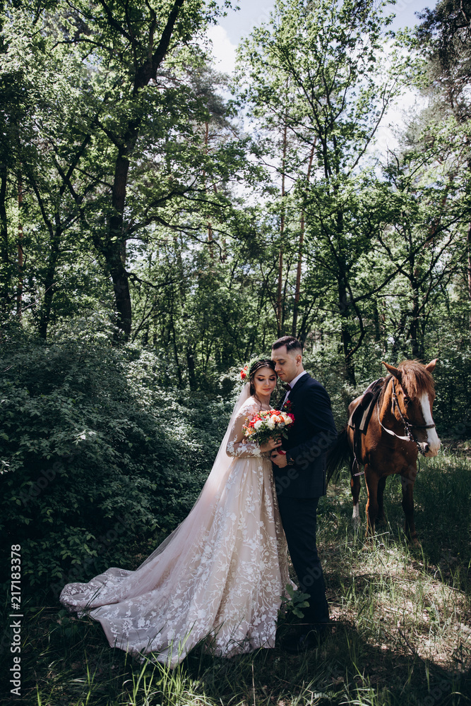 Forest walk of the newlyweds on horseback.