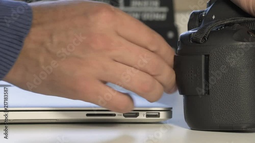 Wallpaper Mural A Photographer insert  memory card.  Notebook and  Clapperboard in background. Extreme Close up Torontodigital.ca