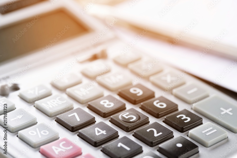 calculator focus at on press button keyboard. calculator color gray and documents pen on table. concept calculate account finance. calculator focus at on press button keyboard. calculator color gray and documents pen on table. concept calculate account finance.
