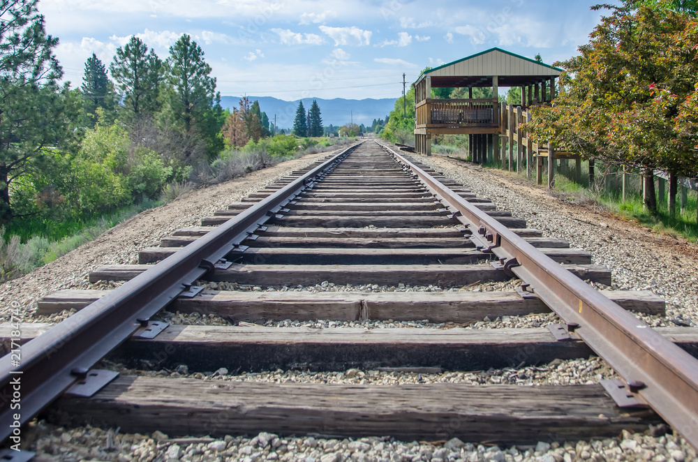 Rural Mountain Railroad Platform Waiting for Train and Passengers Rural Mountain Railroad Platform Waiting for Train and Passengers