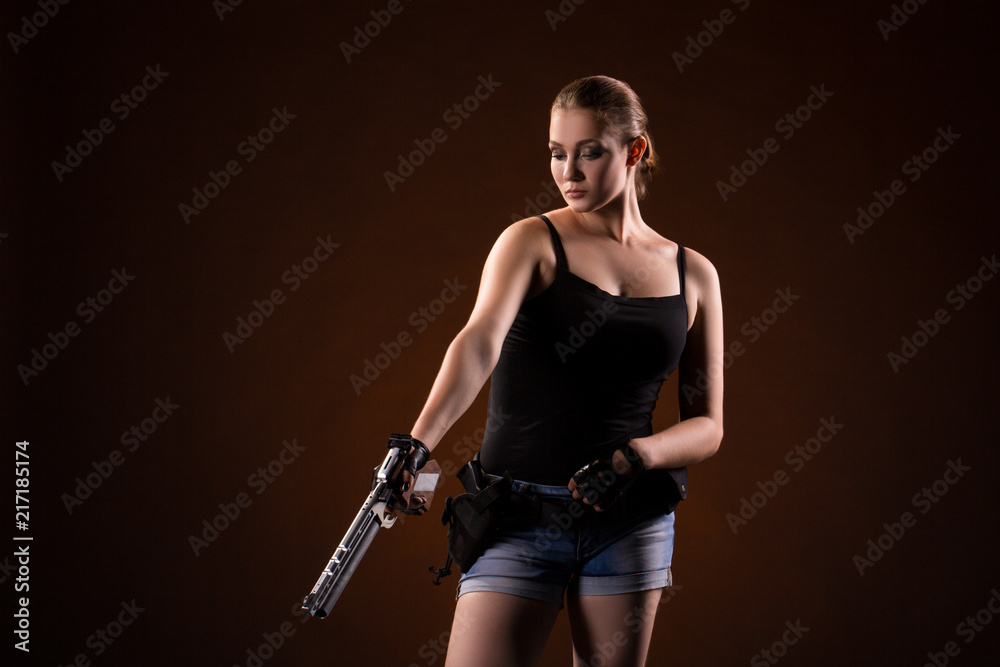 Military woman with a gun over black background Military woman with a gun over black background