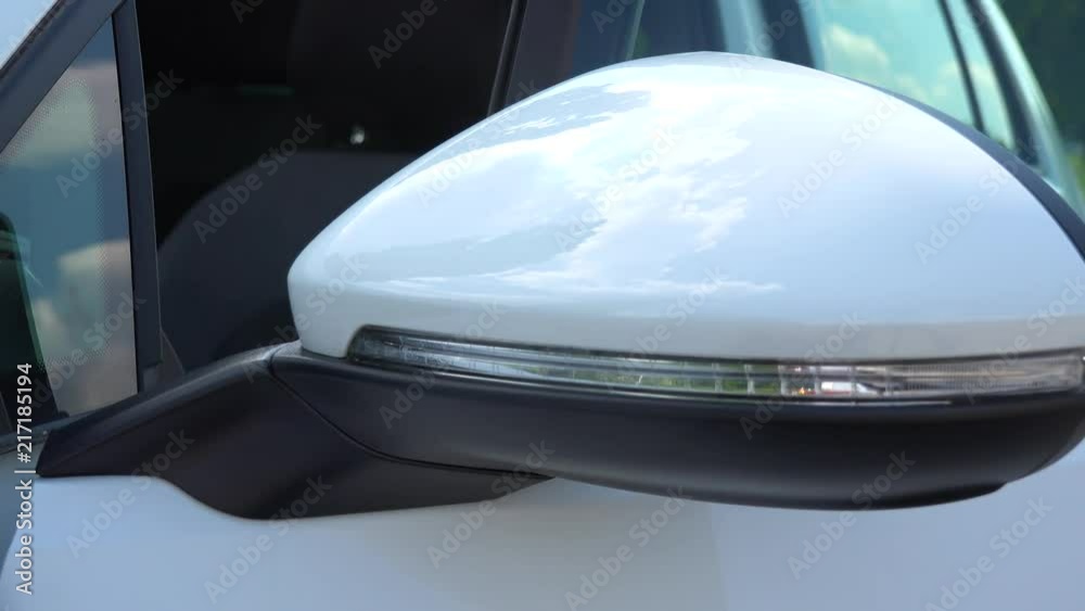 A man unlocks and opens a door of a luxurious car - closeup