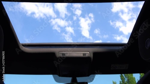 View at the sky through a car roof window photo