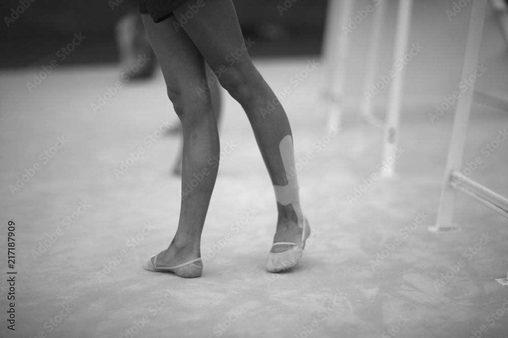 Legs gymnasts in the choreographic position in the rehearsal room in training Legs gymnasts in the choreographic position in the rehearsal room in training