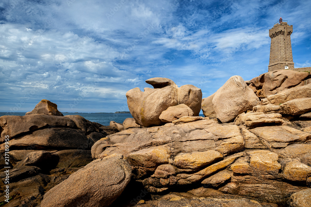 Ploumanac'h Mean Ruz lighthouse between the rocks in pink granite coast, Perros Guirec, Brittany, France.