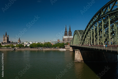 Cityscape of Cologne, Germany: Hohenzollernbruecke, Cologne Cathedral (Koelner Dom) and Gross St. Martin Church photo