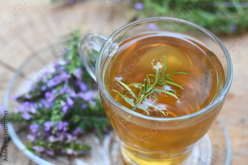 Cup of fresh natural tea on wooden table. Thymus serpyllum natural tea, Breckland Thyme with cup of tea