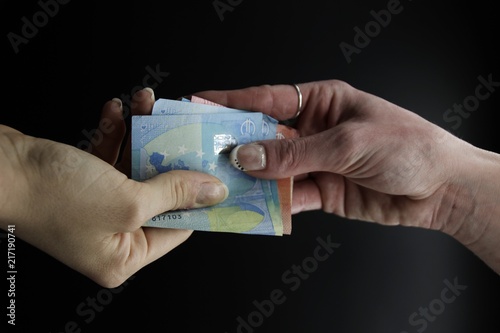 Hands exchanging Euro banknotes. Corruption concept. Italy
