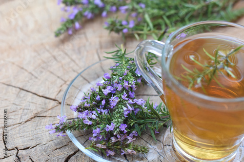 Cup of  fresh natural tea on wooden table.  Thymus serpyllum natural tea, Breckland Thyme  with cup of tea