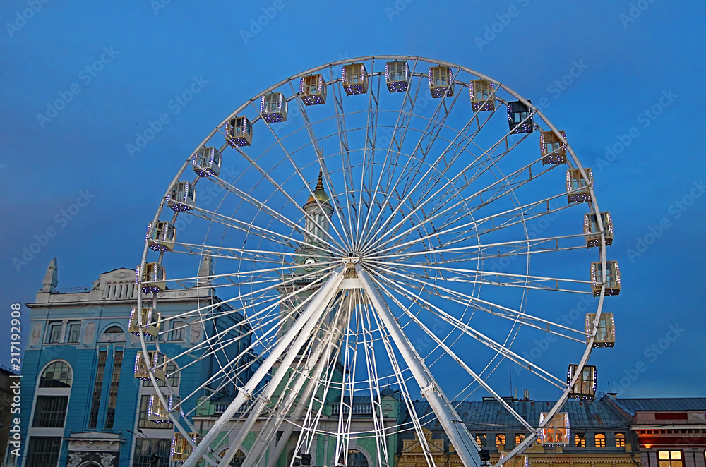 The Ferris wheel in the historical part of Kyiv on the Kontraktova Square on Podol in the evening, Kyiv, Ukraine The Ferris wheel in the historical part of Kyiv on the Kontraktova Square on Podol in the evening, Kyiv, Ukraine