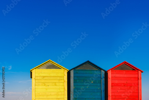 Cabins changers for bathers on a beach of the Mediterranean in summer, colored blue, yellow and red. © Joaquin Corbalan